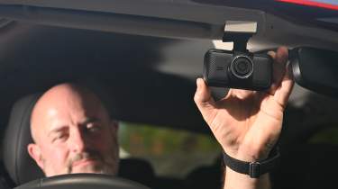 Auto Express products editor Tom Barnard operating a Miofive S1 dash cam